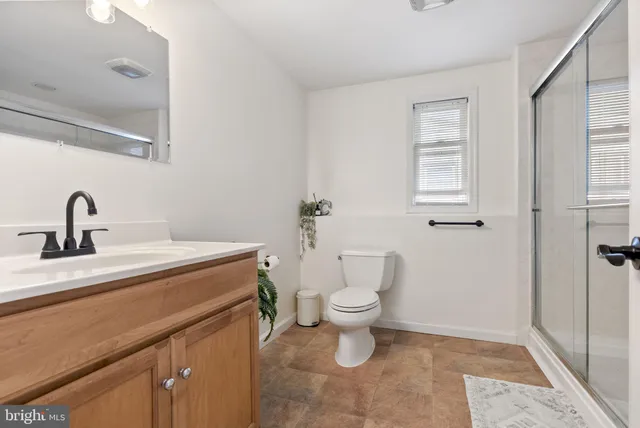a bathroom with a sink toilet and vanity