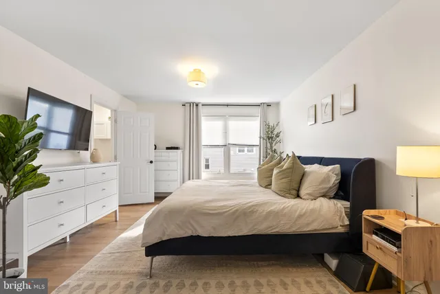 a bedroom with a large bed and a dresser