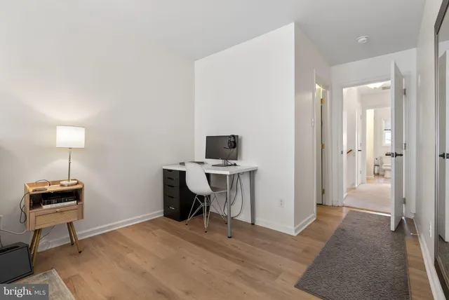 a view of a workspace with furniture and a window