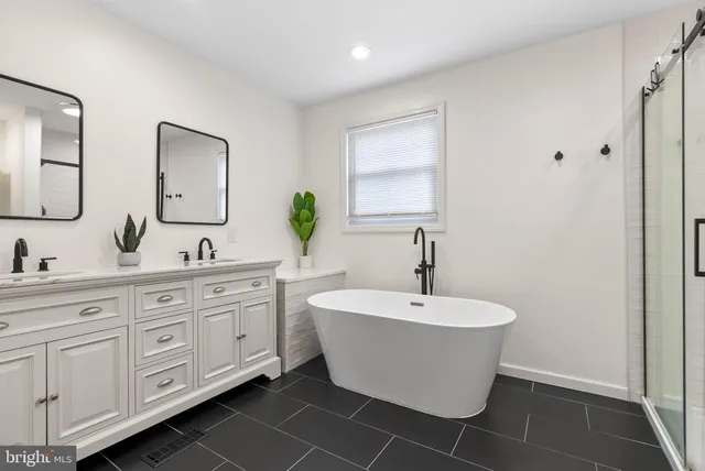 a bathroom with a double vanity sink and a mirror