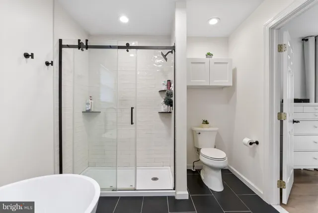 a bathroom with a toilet and a shower