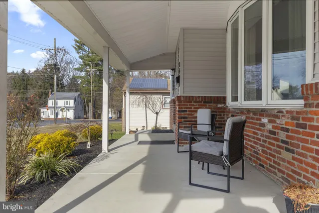 a building outdoor space with patio furniture and potted plants