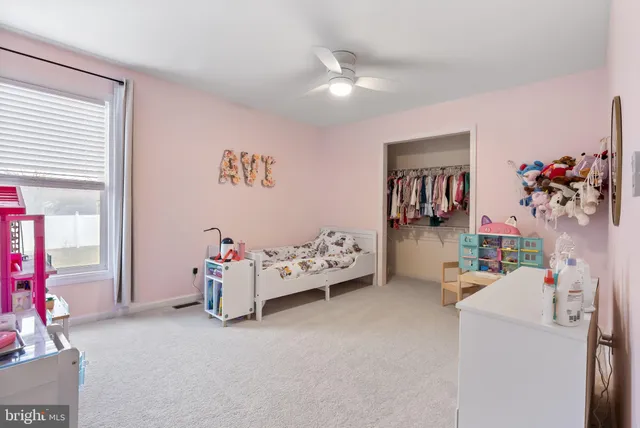 a bedroom with furniture and a flat screen tv