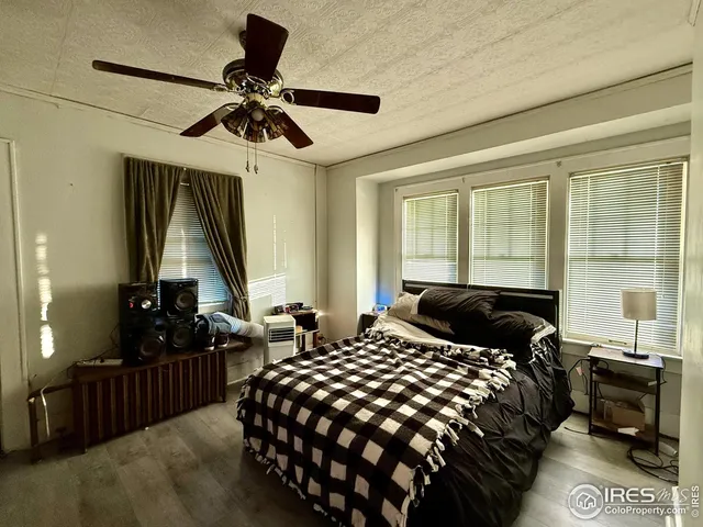 a bedroom with bed and window