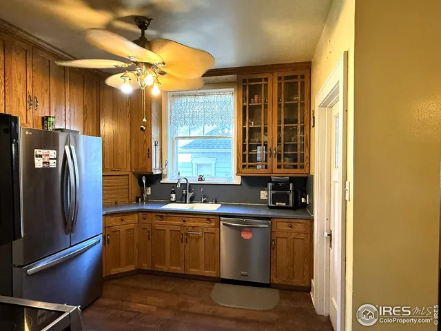 a kitchen with stainless steel appliances granite countertop a sink a stove and a refrigerator