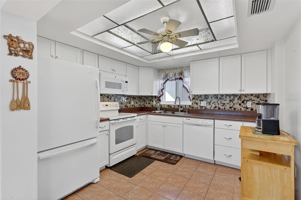 14 Strathmore Boulevard, Unit 14 Sarasota, FL 34233 - Photo 13 of 42 a kitchen with cabinets appliances and a counter top