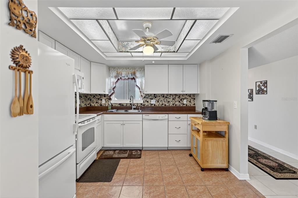 14 Strathmore Boulevard, Unit 14 Sarasota, FL 34233 - Photo 14 of 42 a kitchen with stainless steel appliances granite countertop a refrigerator and a stove top oven