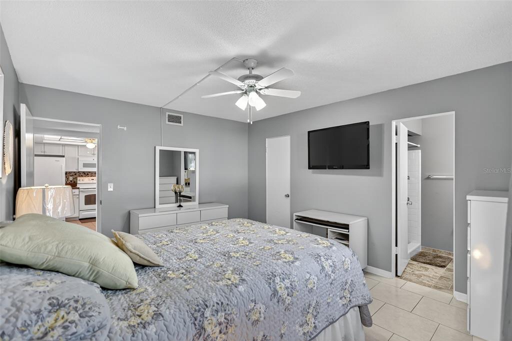 14 Strathmore Boulevard, Unit 14 Sarasota, FL 34233 - Photo 18 of 42 a bedroom with a bed and a flat screen tv