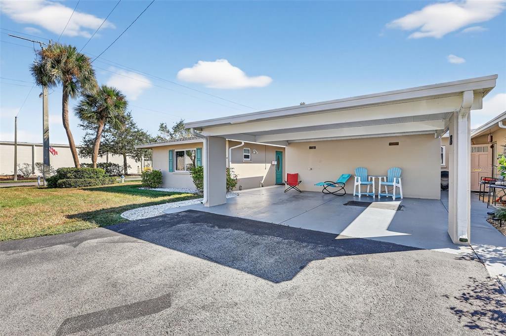 14 Strathmore Boulevard, Unit 14 Sarasota, FL 34233 - Photo 2 of 42 a view of a house with a backyard and a garage