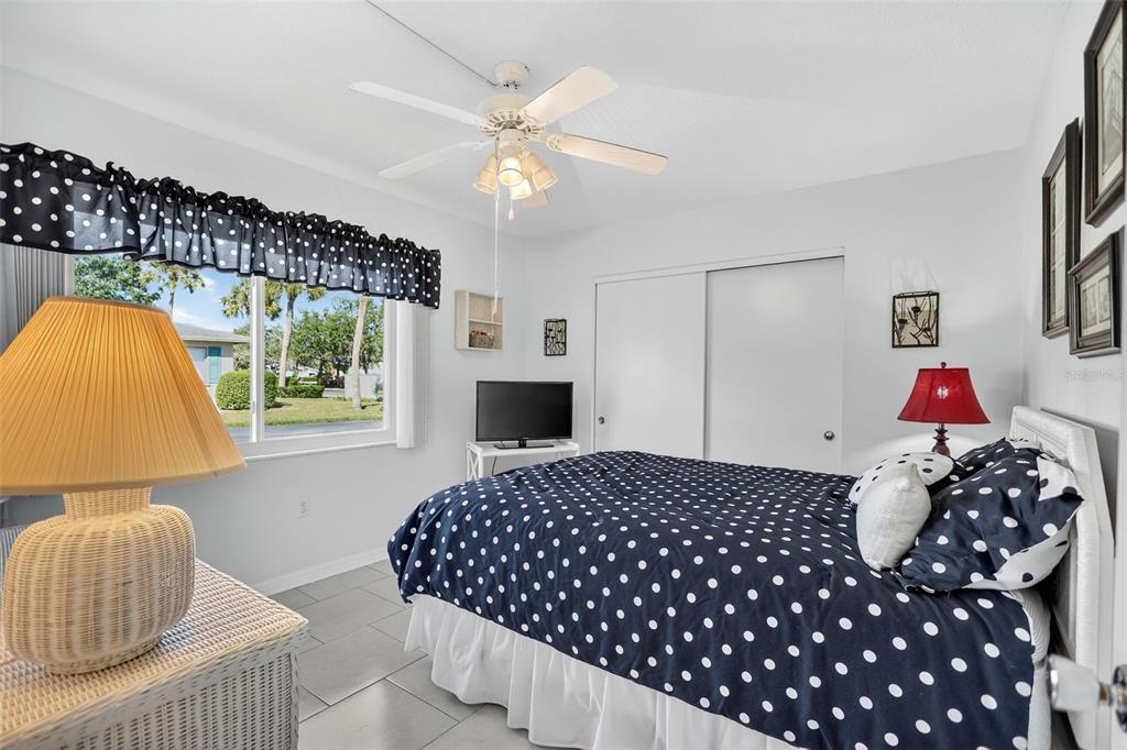 14 Strathmore Boulevard, Unit 14 Sarasota, FL 34233 - Photo 23 of 42 a bedroom with a bed and a window