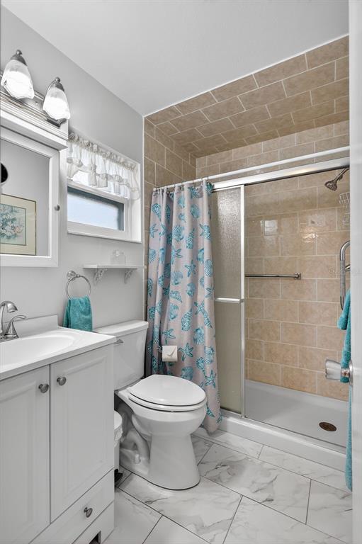 14 Strathmore Boulevard, Unit 14 Sarasota, FL 34233 - Photo 26 of 42 a bathroom with a toilet sink and shower