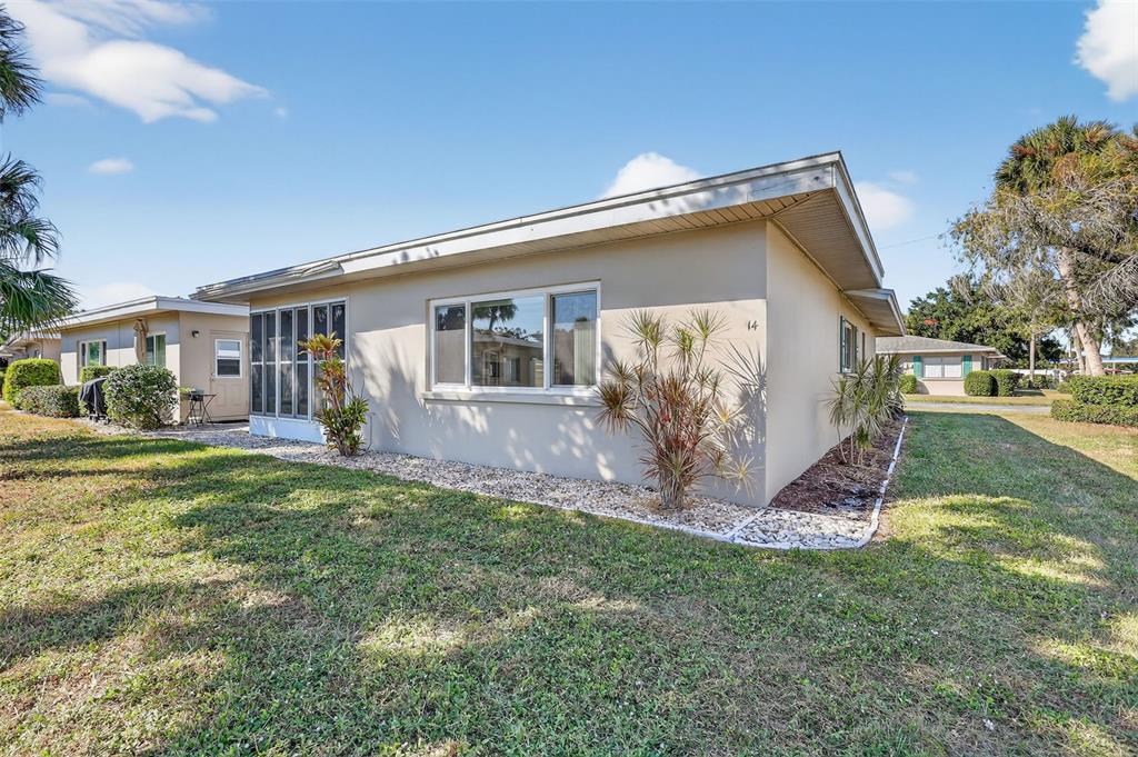 14 Strathmore Boulevard, Unit 14 Sarasota, FL 34233 - Photo 31 of 42 a view of a house with a yard