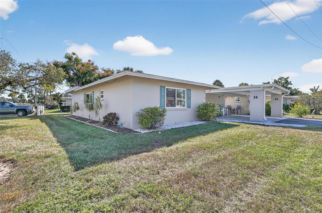 14 Strathmore Boulevard, Unit 14 Sarasota, FL 34233 - Photo 32 of 42 a view of a house with a yard