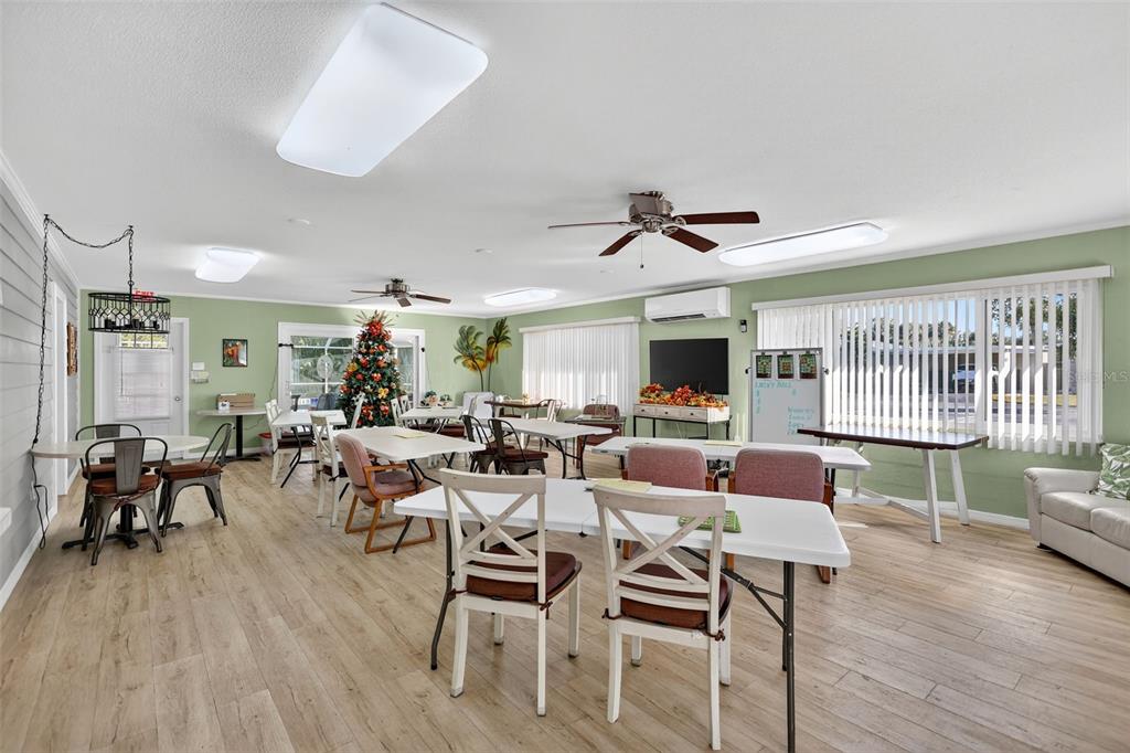 14 Strathmore Boulevard, Unit 14 Sarasota, FL 34233 - Photo 35 of 42 a living room with furniture a flat screen tv and a large window