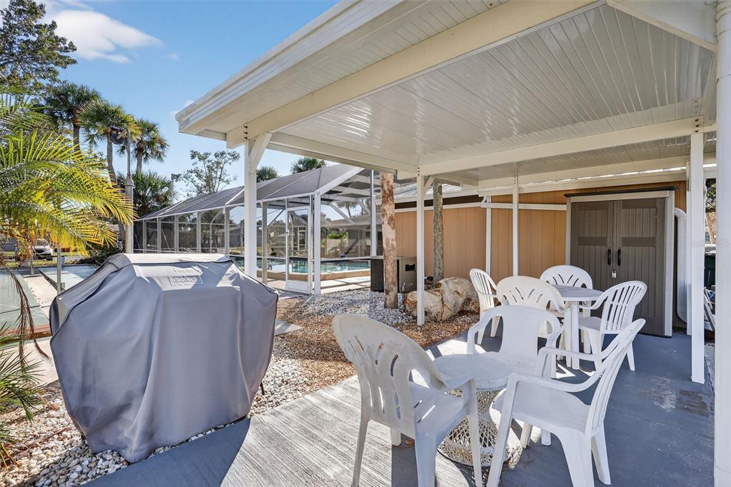 14 Strathmore Boulevard, Unit 14 Sarasota, FL 34233 - Photo 41 of 42 a view of a patio with couches table and chairs and potted plants