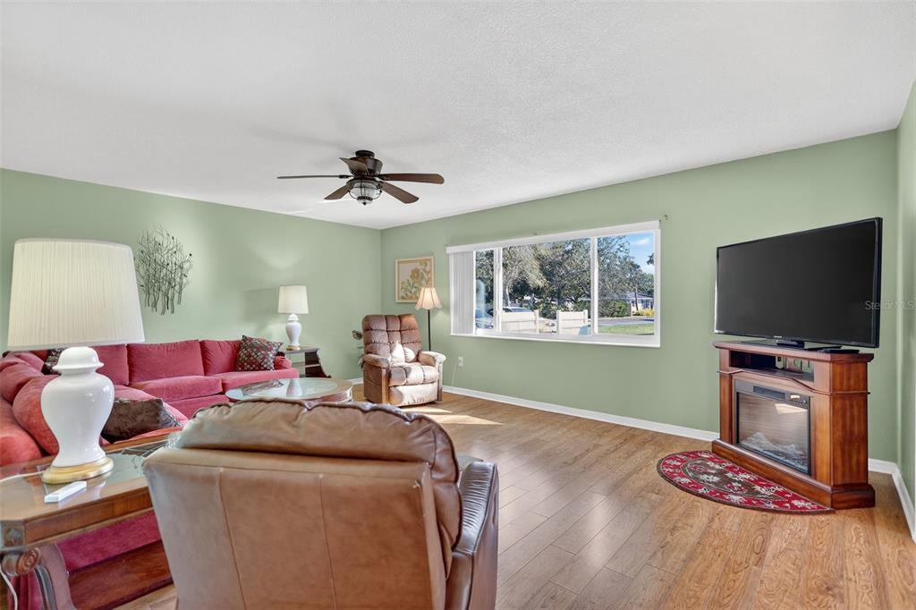 14 Strathmore Boulevard, Unit 14 Sarasota, FL 34233 - Photo 8 of 42 a living room with furniture and a flat screen tv