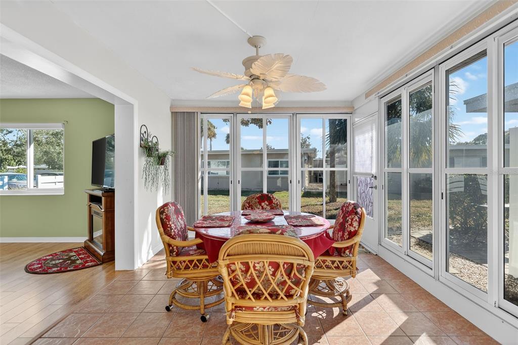 14 Strathmore Boulevard, Unit 14 Sarasota, FL 34233 - Photo 9 of 42 a dining room with furniture and a floor to ceiling window