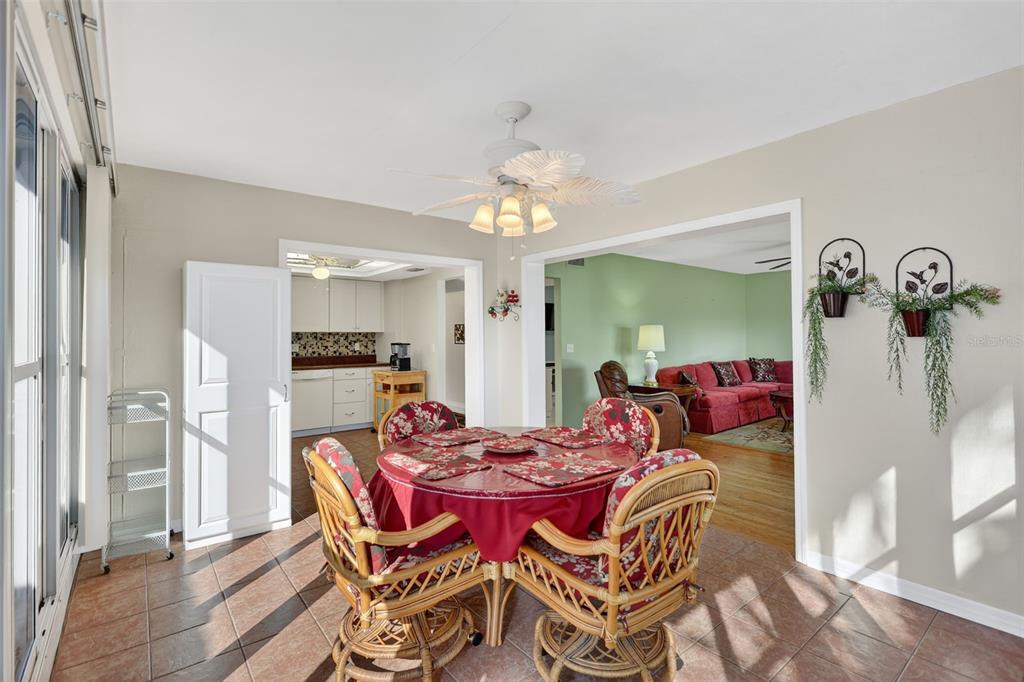 14 Strathmore Boulevard, Unit 14 Sarasota, FL 34233 - Photo 10 of 42 a view of a dining room with furniture and a chandelier