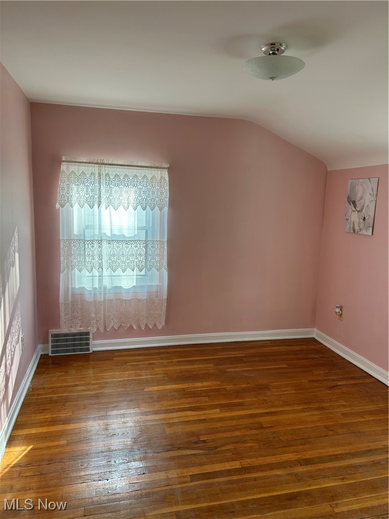 1094 Plainfield Road Cleveland, OH 44121 - Photo 26 of 41 Additional living space with lofted ceiling and hardwood-flooring