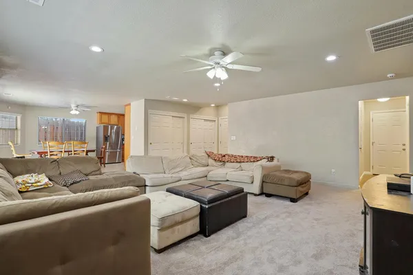 a spacious bedroom with a bed a couch and a window