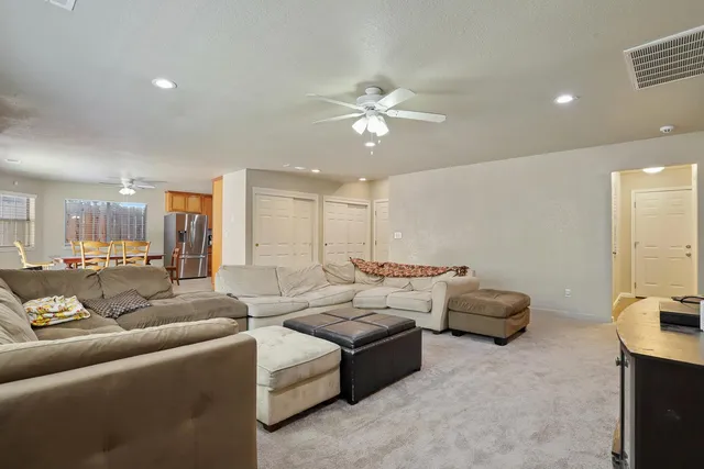 a spacious bedroom with a bed a couch and a window