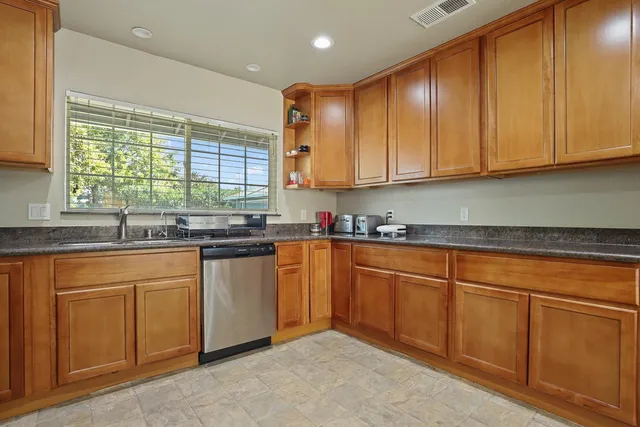 a kitchen with stainless steel appliances granite countertop furniture and a refrigerator