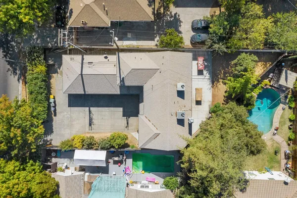 an aerial view of a house with a yard