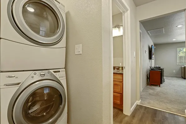 a utility room with sink dryer and washer