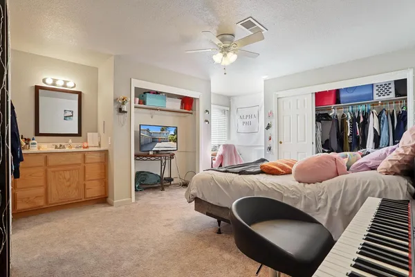a bedroom with a bed and a chandelier
