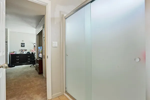 a spacious bedroom with a bed dresser and a mirror