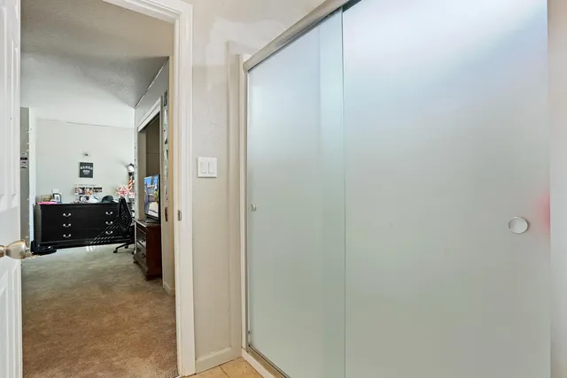 a spacious bedroom with a bed dresser and a mirror