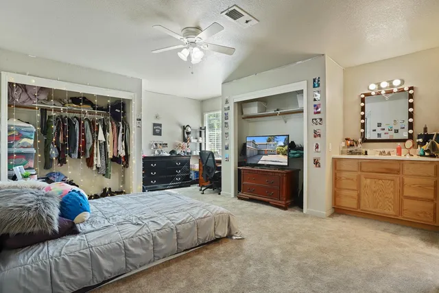 a bedroom with a bed and a television