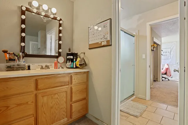 a living room with furniture a flat screen tv and a window