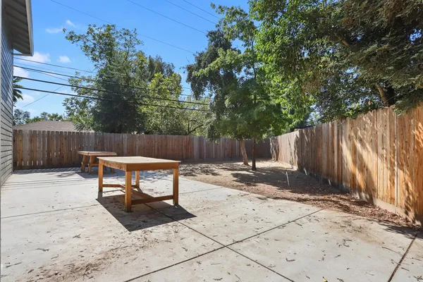 a backyard of a house with table and chairs