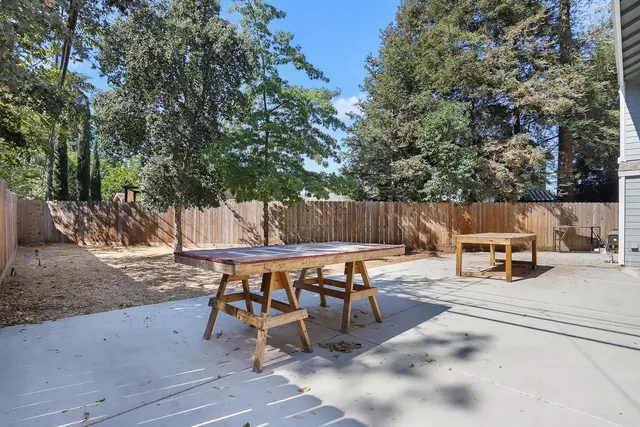 a backyard of a house with a tree