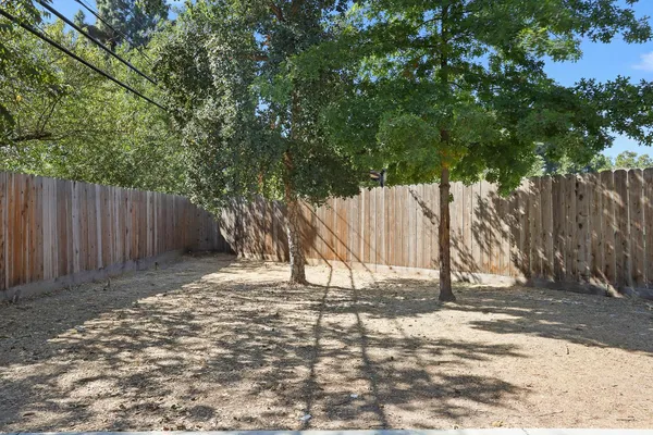 a backyard of a house with table and chairs