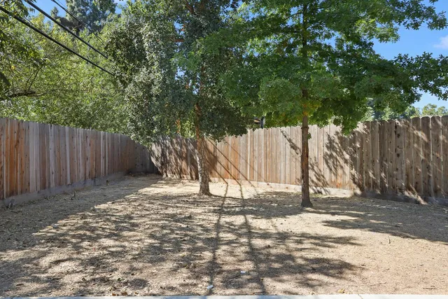 a backyard of a house with table and chairs