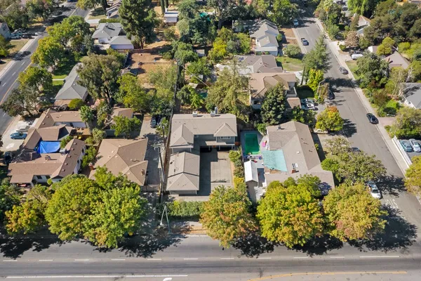 an aerial view of a house with a yard