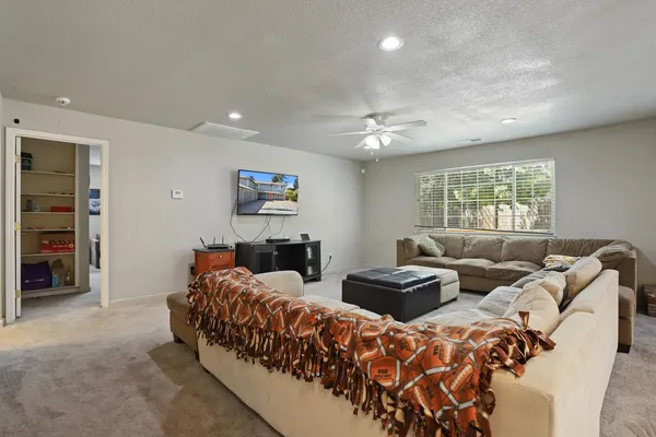a living room with furniture and a chandelier