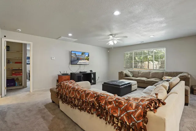 a living room with furniture and a chandelier