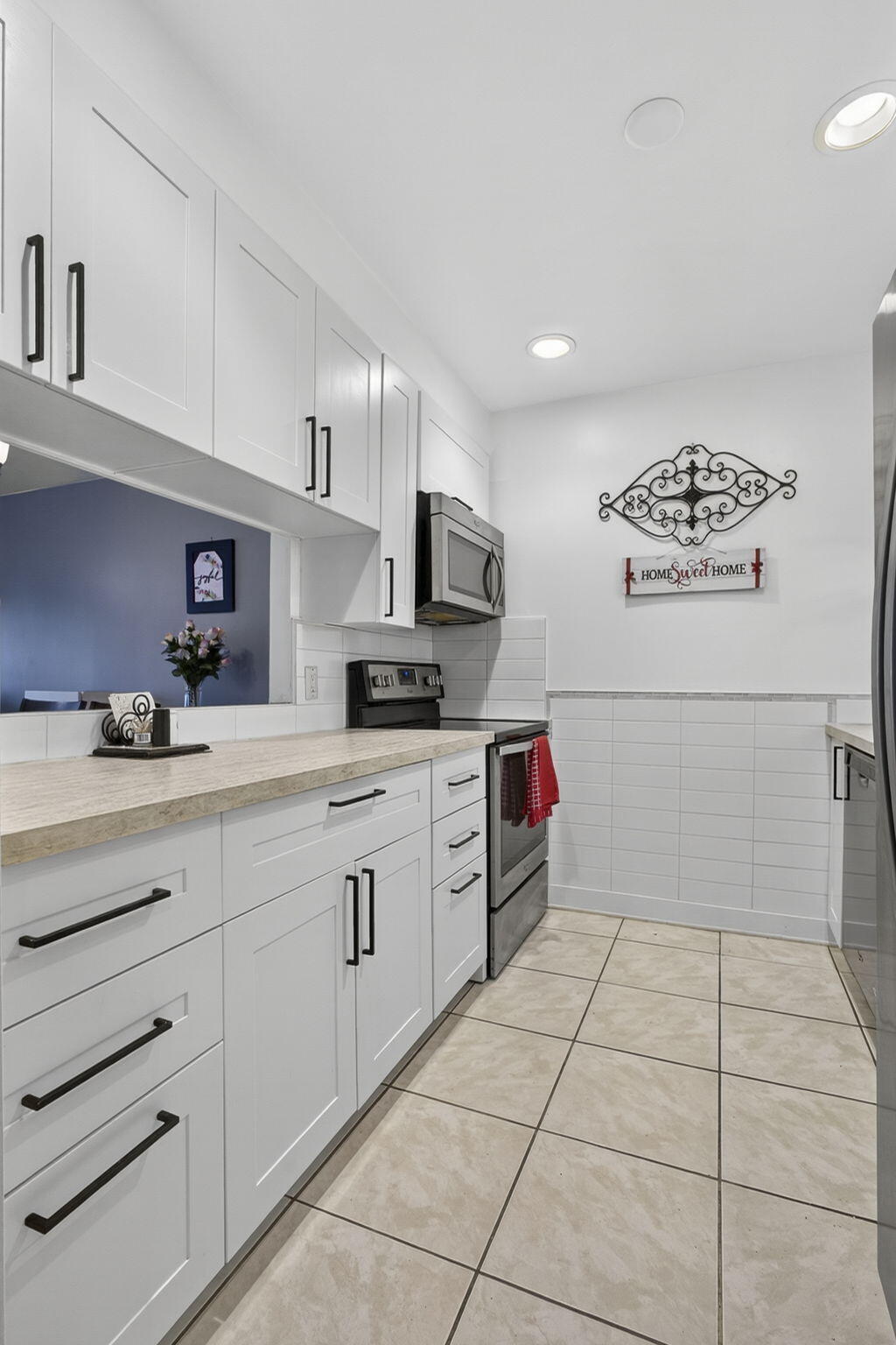 12001 Poinciana Boulevard, Unit 204 Royal Palm Beach, FL 33411 - Photo 13 of 42 a kitchen with granite countertop a stove a sink and cabinets