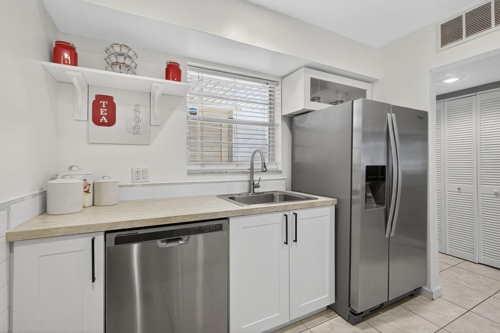 12001 Poinciana Boulevard, Unit 204 Royal Palm Beach, FL 33411 - Photo 16 of 42 a kitchen with stainless steel appliances a refrigerator and a sink