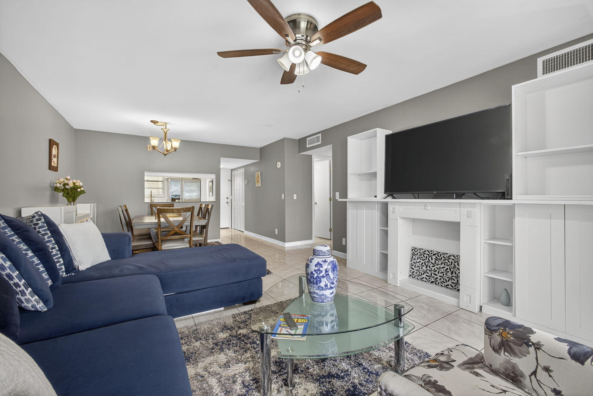 12001 Poinciana Boulevard, Unit 204 Royal Palm Beach, FL 33411 - Photo 22 of 42 a living room with furniture a flat screen tv and a fireplace