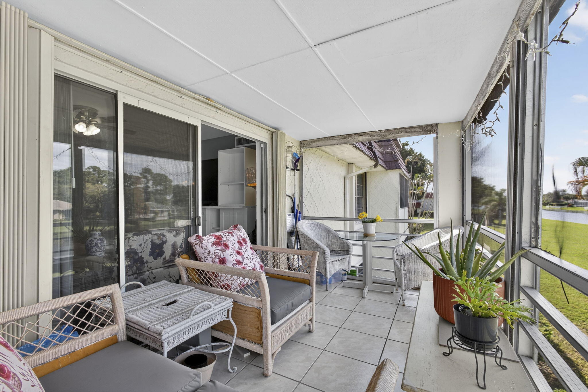12001 Poinciana Boulevard, Unit 204 Royal Palm Beach, FL 33411 - Photo 25 of 42 a living room with furniture and floor to ceiling windows