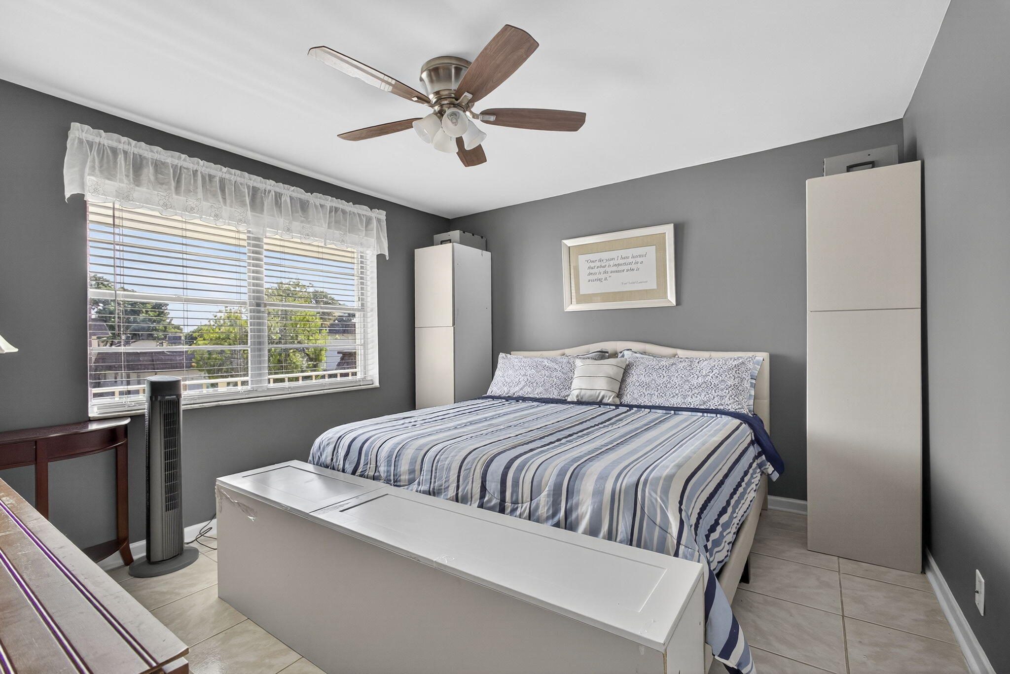 12001 Poinciana Boulevard, Unit 204 Royal Palm Beach, FL 33411 - Photo 29 of 42 a bedroom with a large bed and a large window