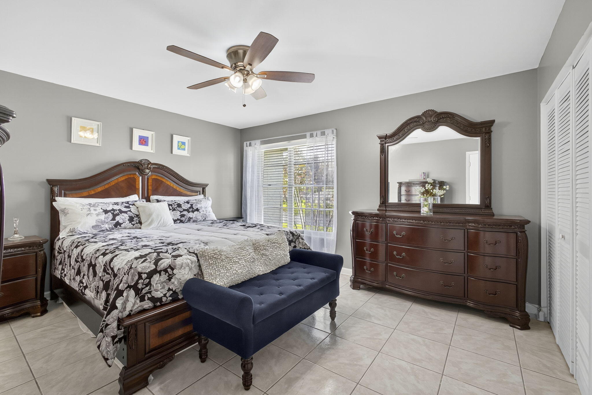 12001 Poinciana Boulevard, Unit 204 Royal Palm Beach, FL 33411 - Photo 31 of 42 a bedroom with a bed and a chandelier