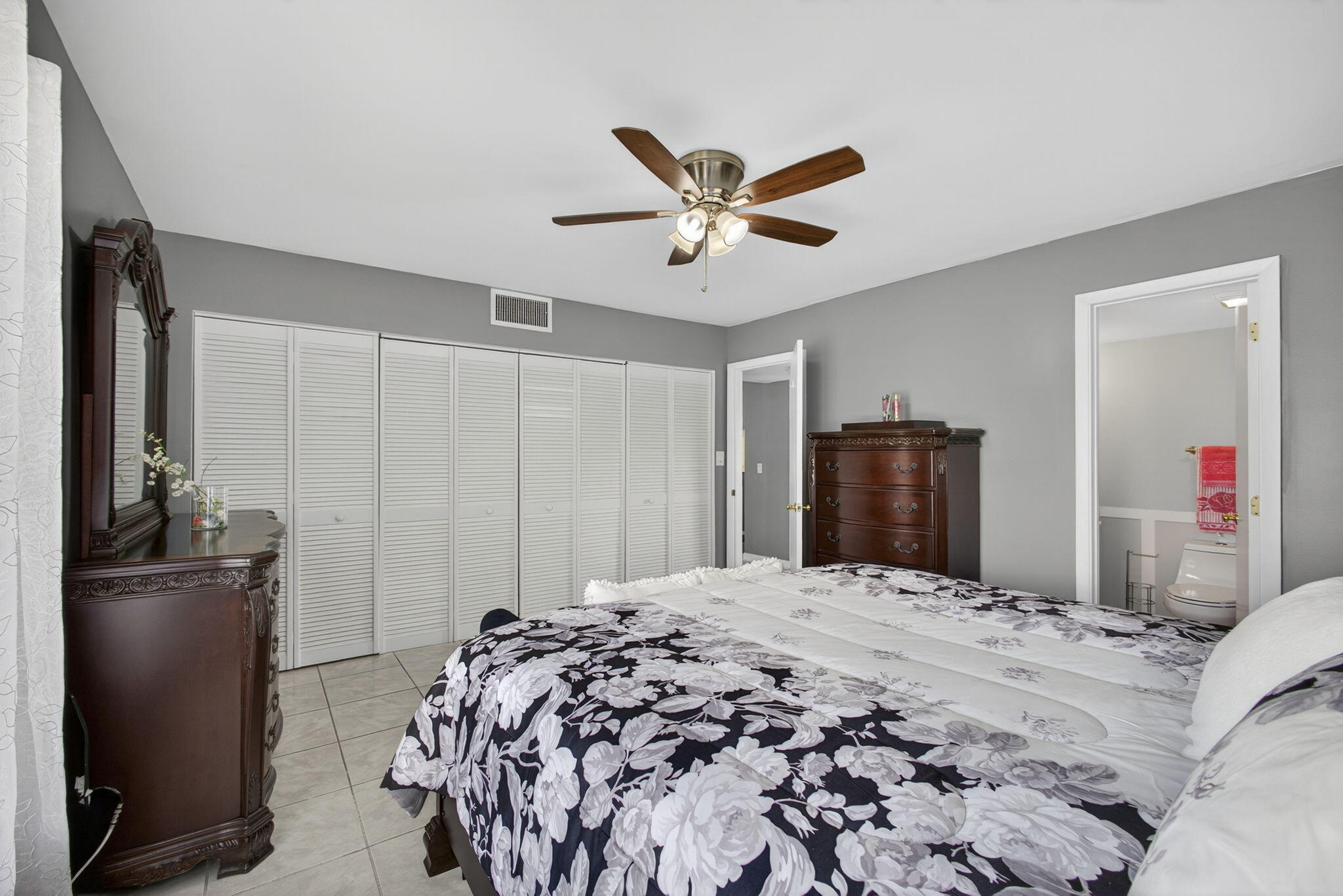 12001 Poinciana Boulevard, Unit 204 Royal Palm Beach, FL 33411 - Photo 33 of 42 a bedroom with a bed and a television