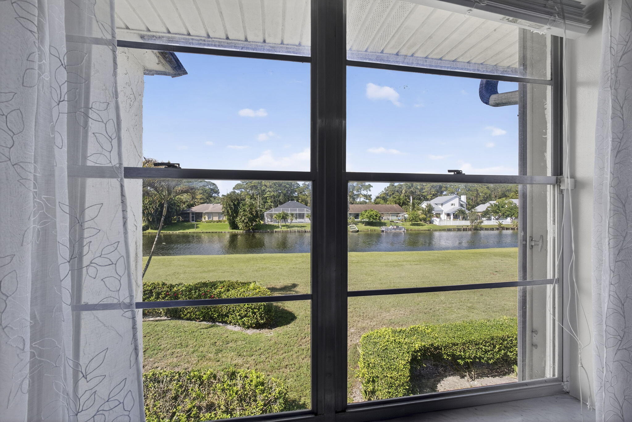 12001 Poinciana Boulevard, Unit 204 Royal Palm Beach, FL 33411 - Photo 34 of 42 a view of a glass door with a yard from a window