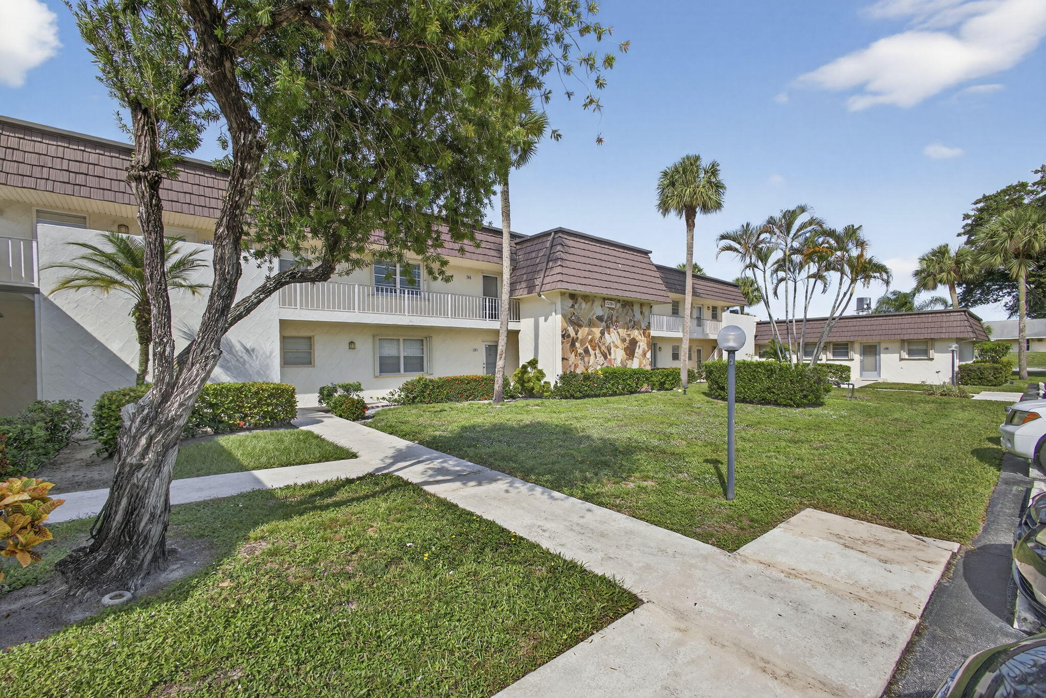 12001 Poinciana Boulevard, Unit 204 Royal Palm Beach, FL 33411 - Photo 41 of 42 a front view of a house with a yard
