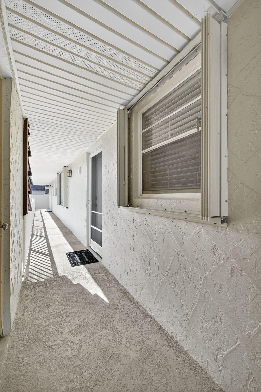 12001 Poinciana Boulevard, Unit 204 Royal Palm Beach, FL 33411 - Photo 9 of 42 a view of a house with a sink and a yard